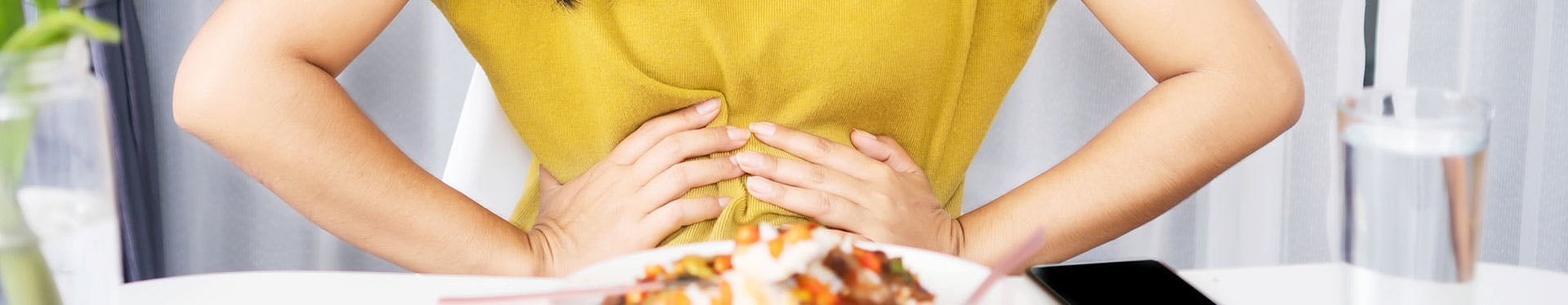 Woman with indigestion after eating food