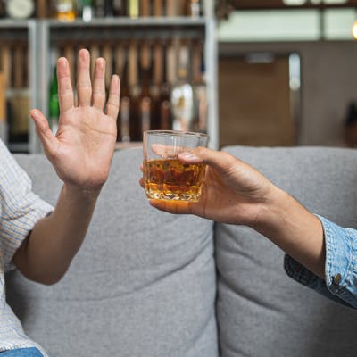 Man refusing an offer for alcohol. 