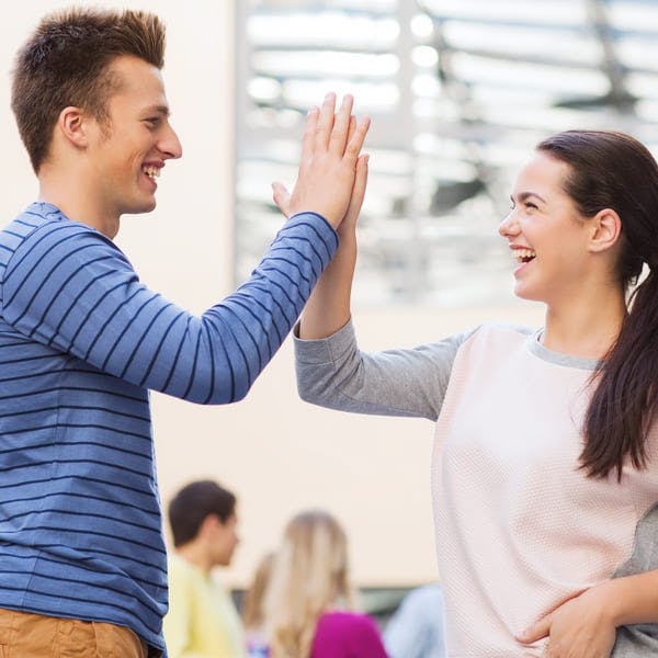 Happy friends high fiving. 