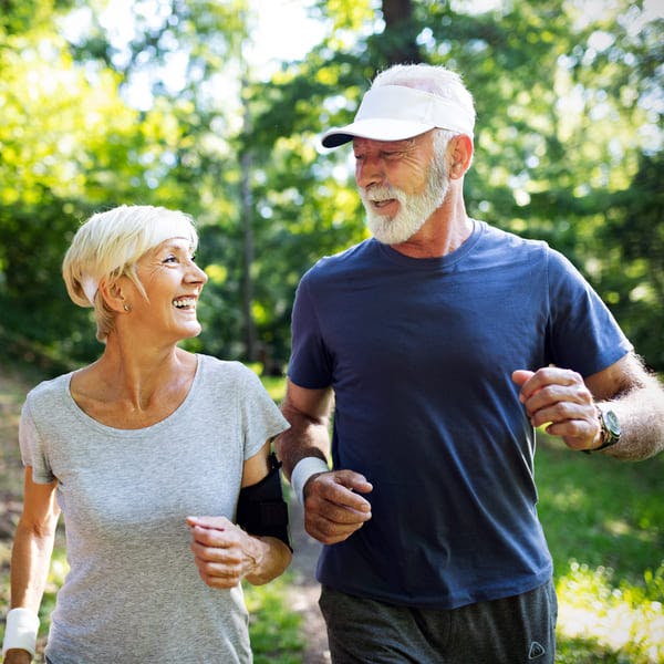 Older couple walking in the park.