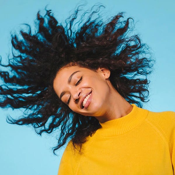 Young woman tossing hair