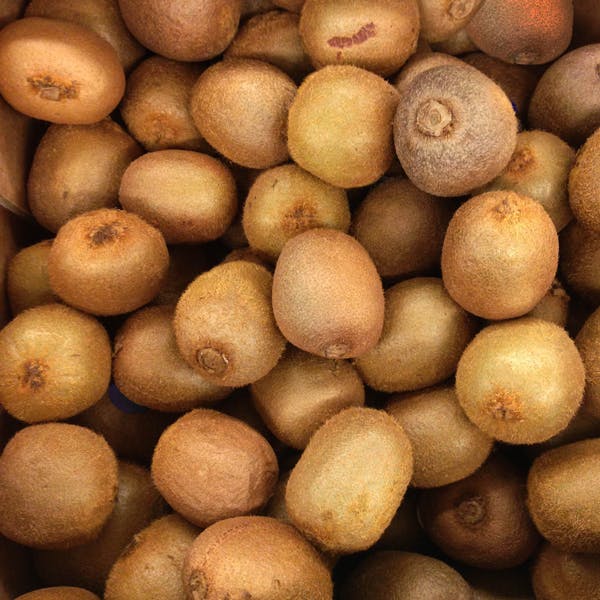 Close up of a pile of kiwi. 