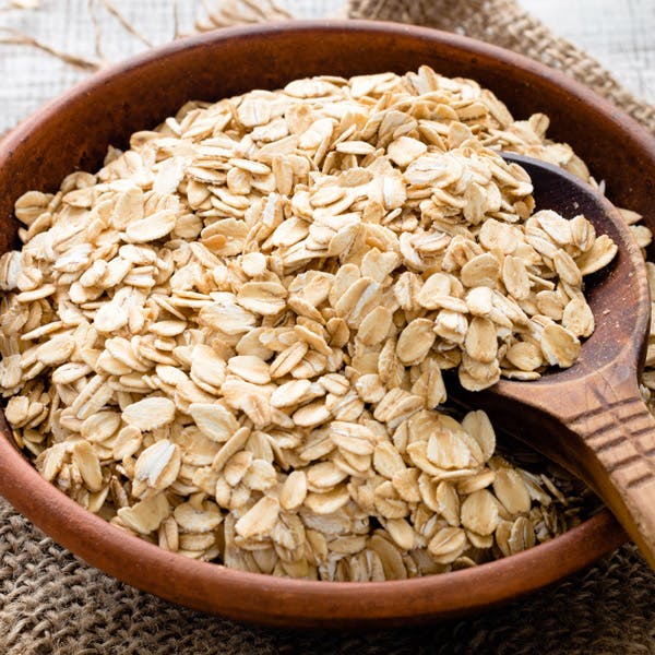 A bowl of oats with a serving sppon.