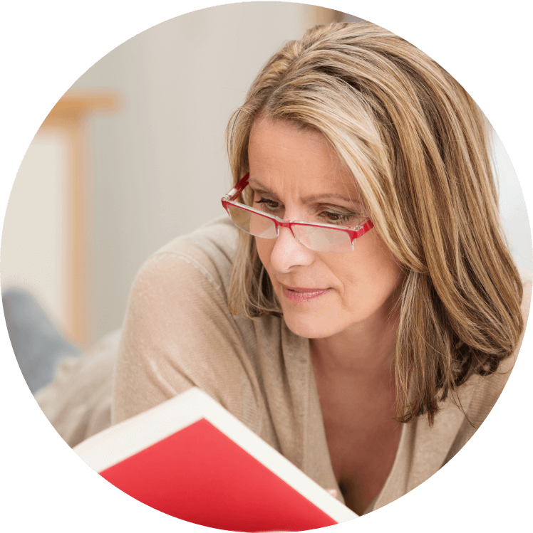 Woman in glasses reading a book