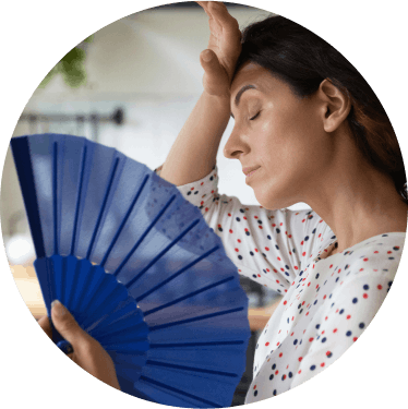 Tired woman using a fan