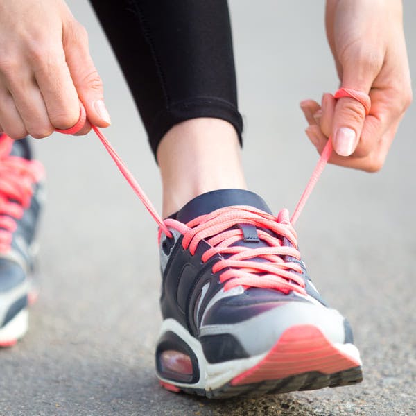 Woman tying shoelaces before running