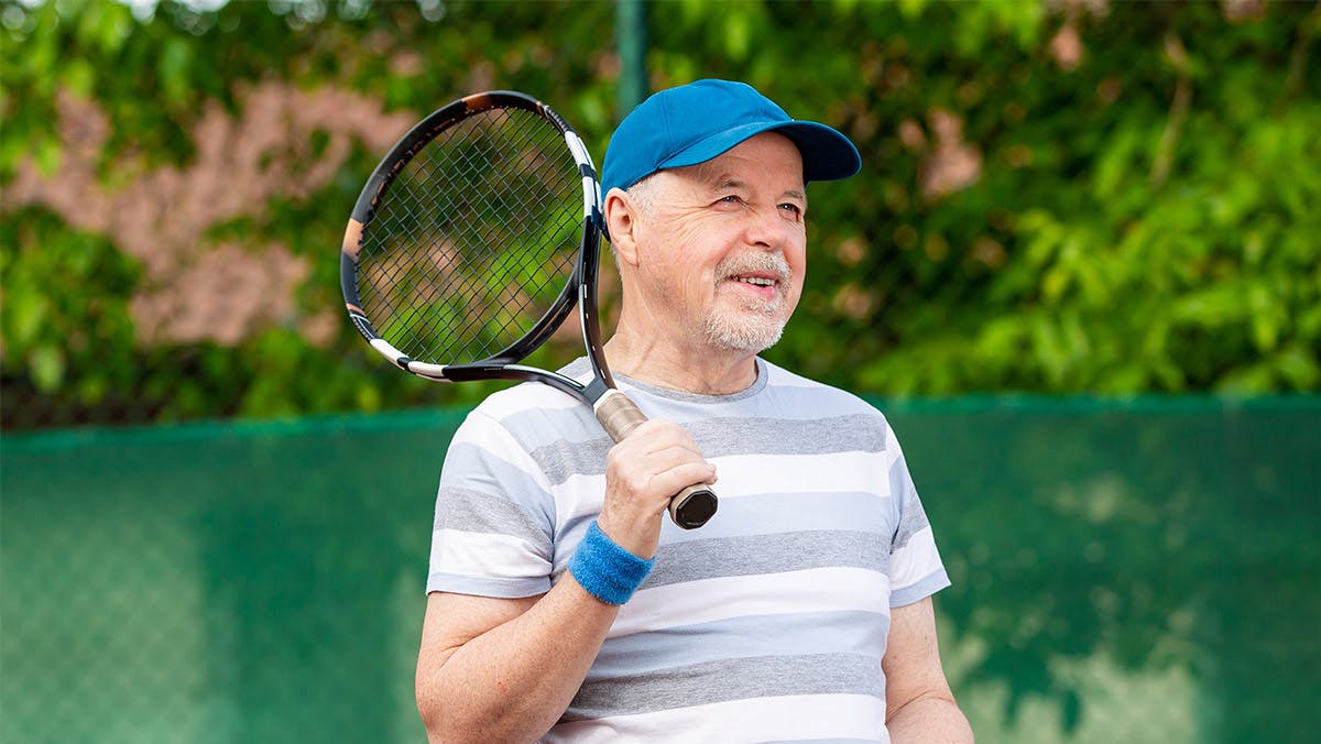middle-aged man playing tennis