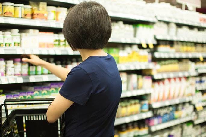 Woman browsing vitamin aisle