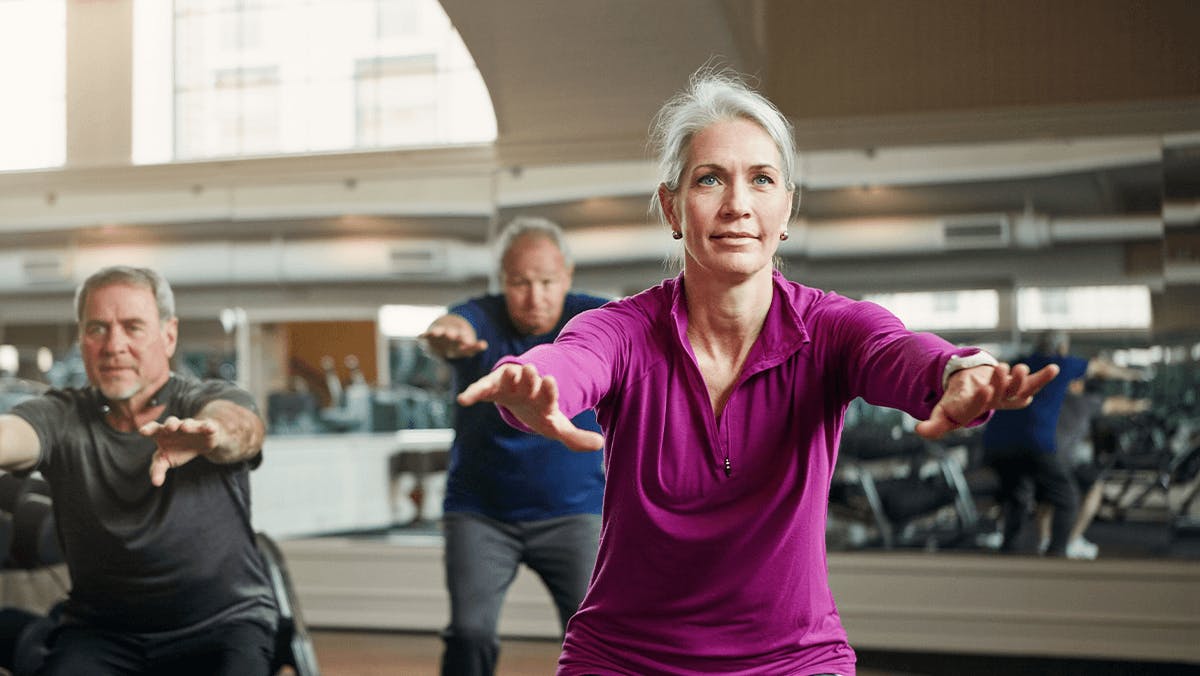 Mature group of men and women exercising at gym Mature group of men and women exercising at gym