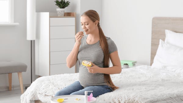 Pregnant woman taking vitamins