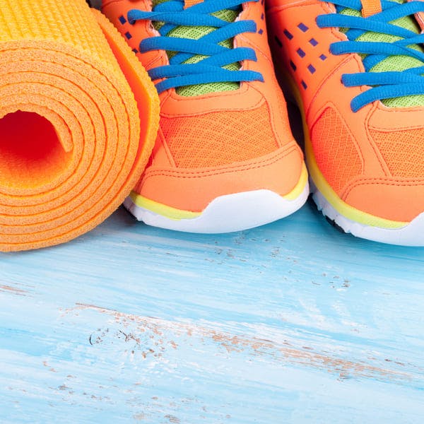 Orange yoga mat and sneakers
