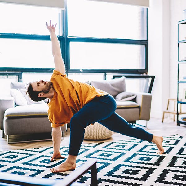Person doing yoga stretches in their living room