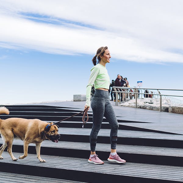 Woman walking her dog outside