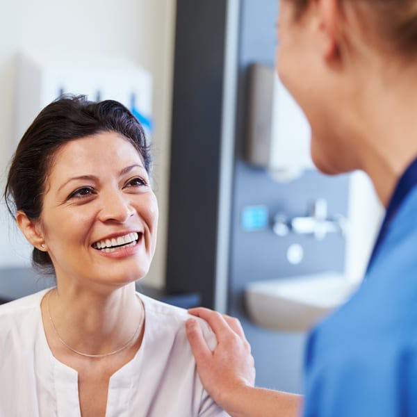 Female patient being reassured by doctor