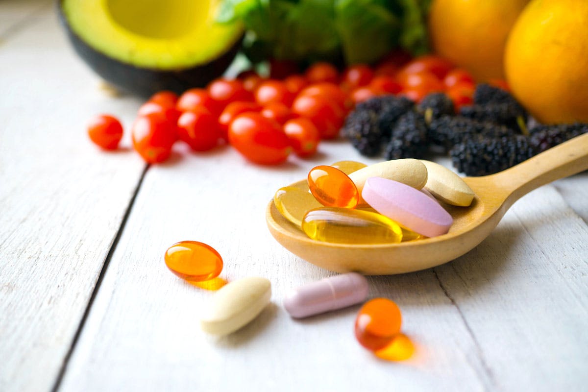 1041373417 fresh fruit and spoonful of vitamins