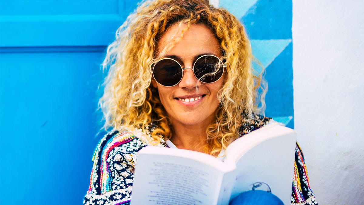 young woman reading book