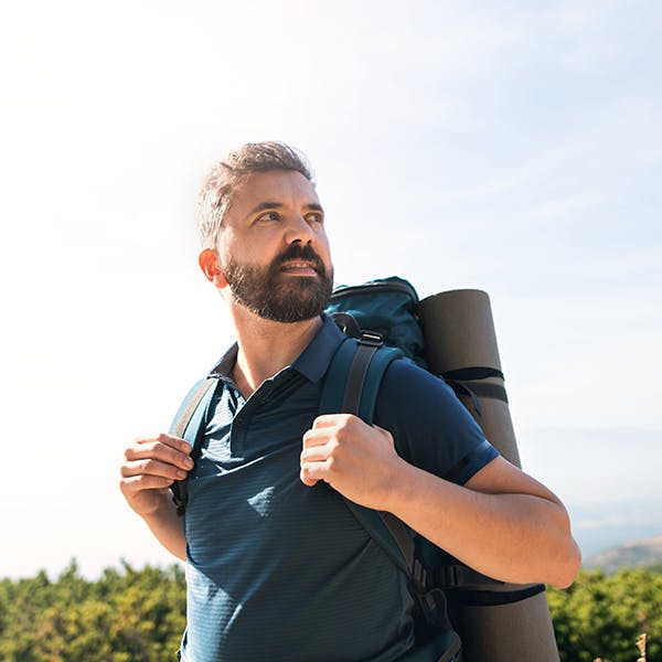 Man with a backpack hiking outside