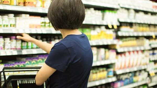 women browsing vitamin aisle