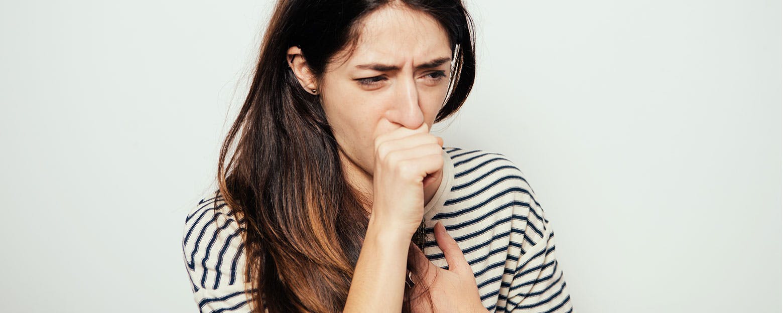 Woman coughing from chest congestion