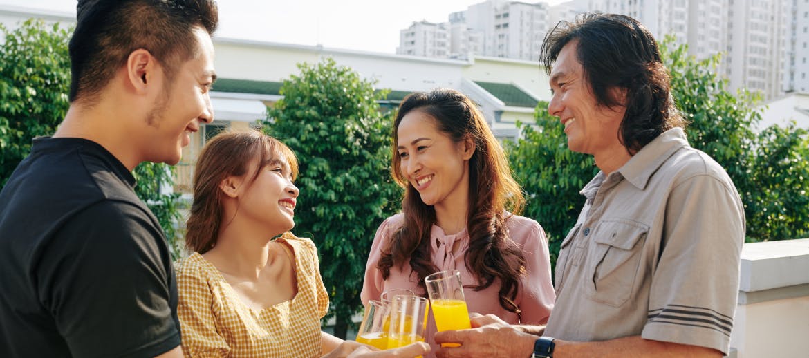 A group of friends drinking orange juice