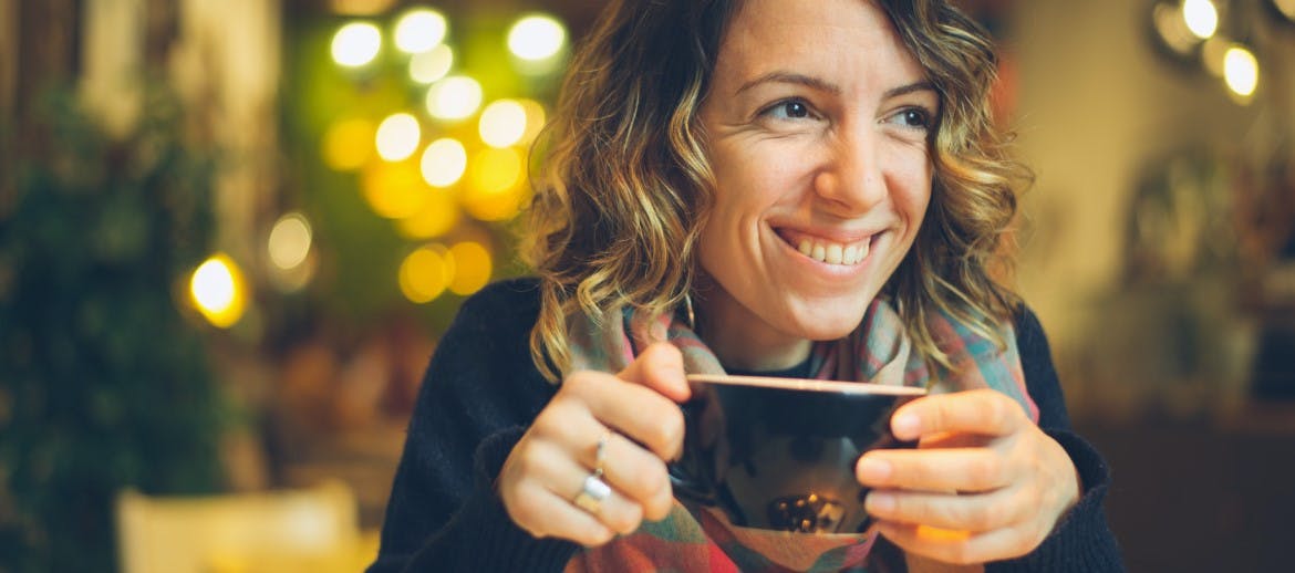 A women drinking a cup of tea