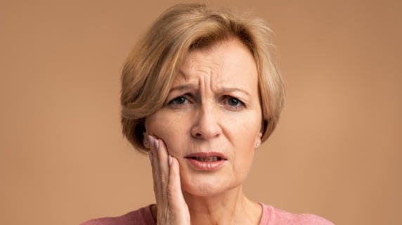 Woman experiencing gum discomfort