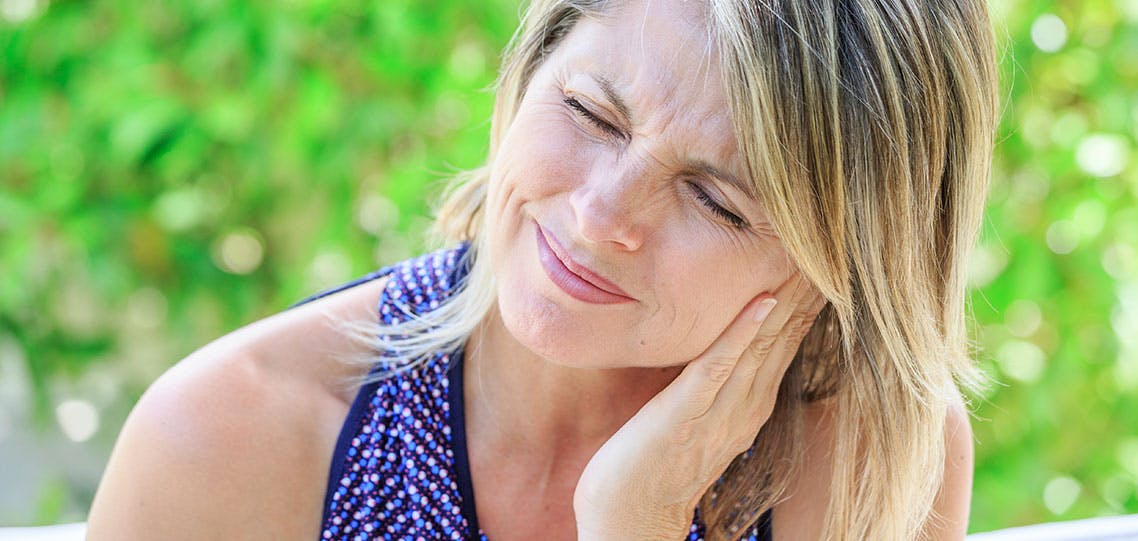 Blonde woman experiencing pain in mouth Blonde woman experiencing pain in mouth