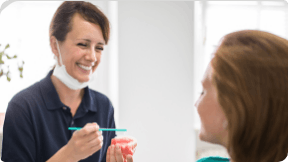 A dentist holding a set of full dentures