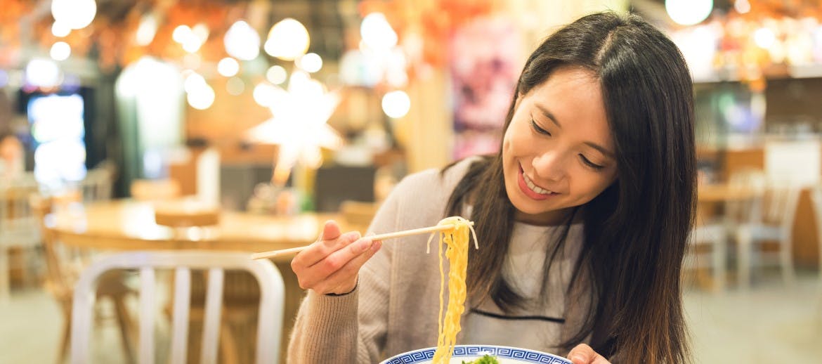 A women eating noodles