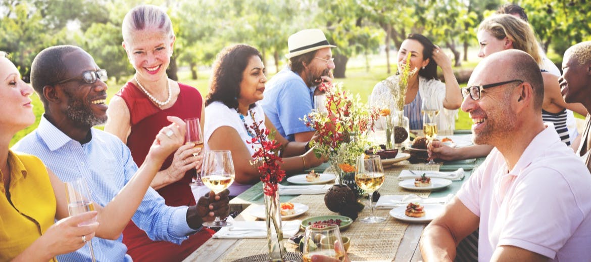 A large group of people enjoying a meal at a table