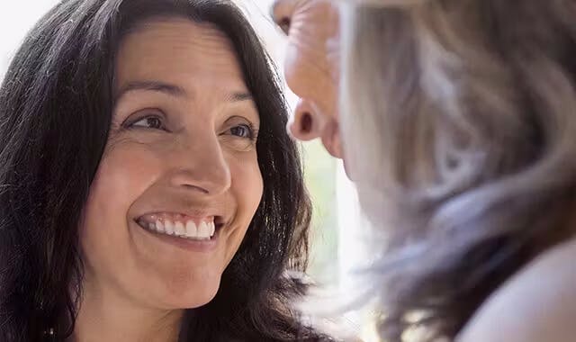 Two women smiling at each other