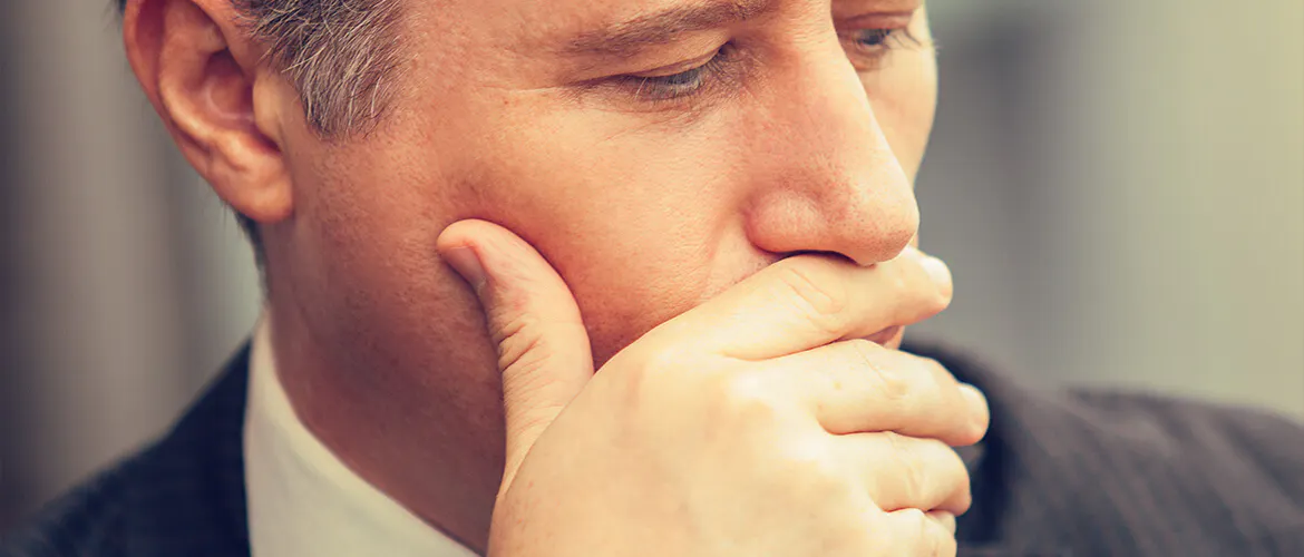 Man covering his mouth with his hand
