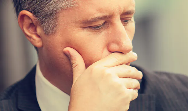 Man covering his mouth with his hand