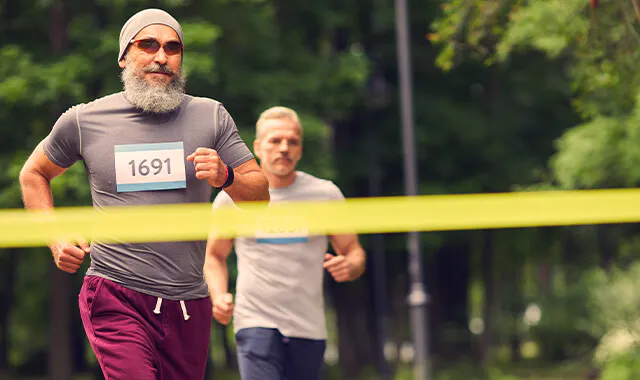 Men running, arriving at the finish line