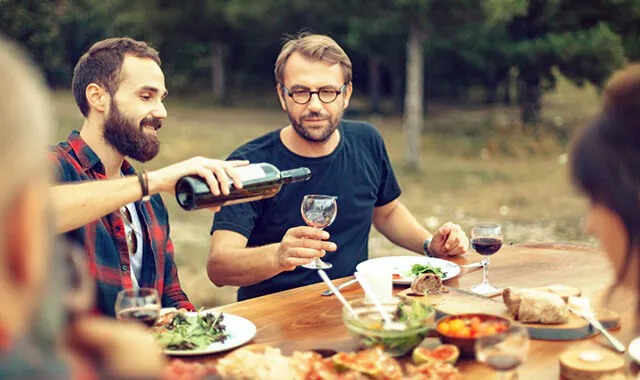 Friends drinking wine outdoors