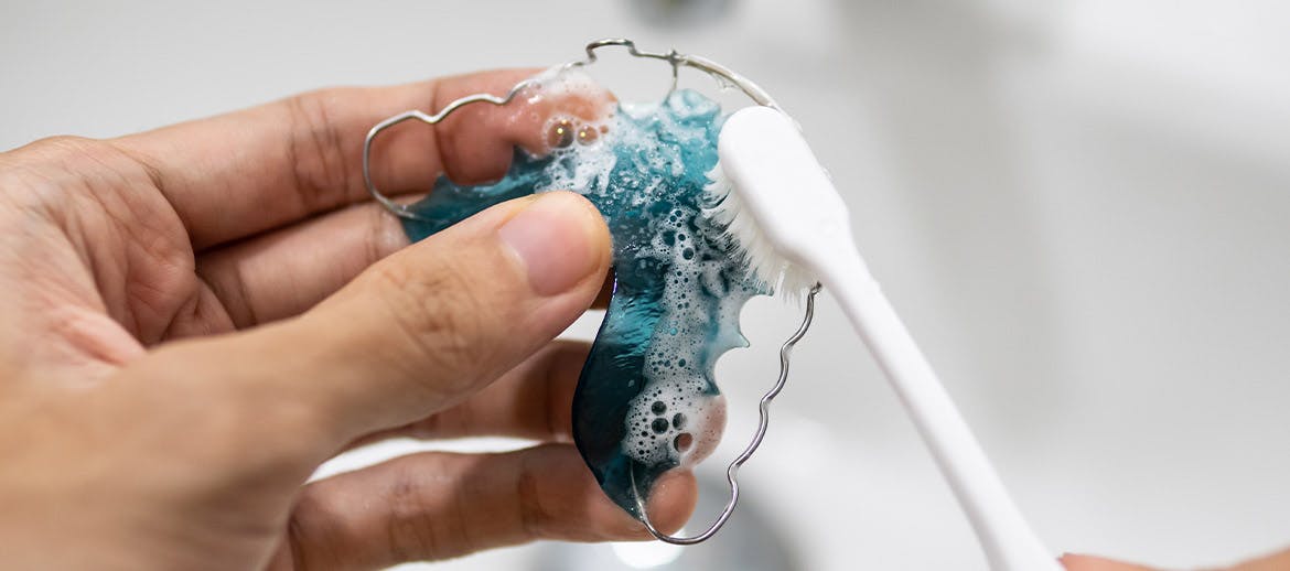 toothpaste being squeezed onto a tooth brush