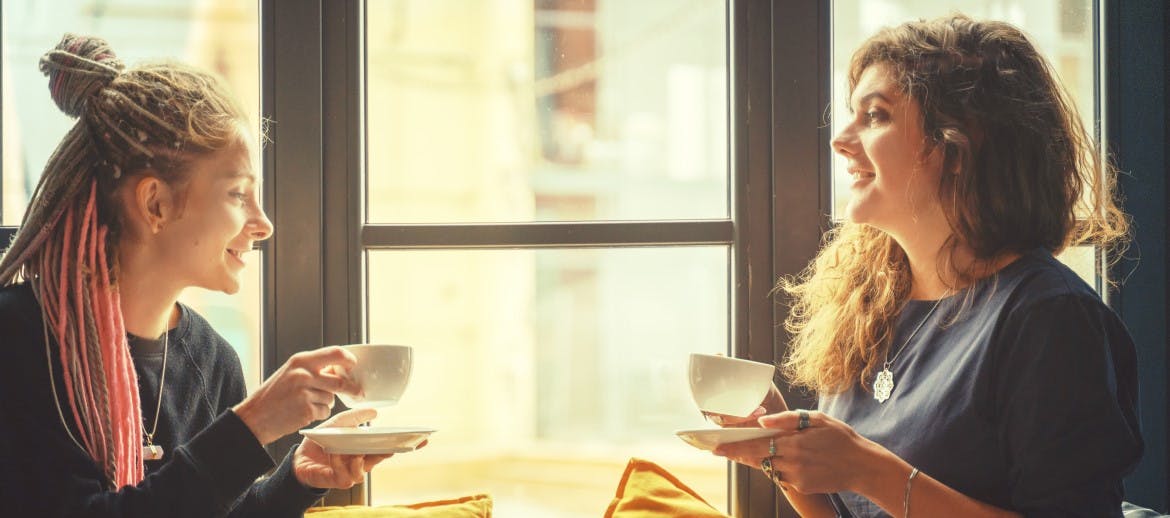 two women enjoying a coffee