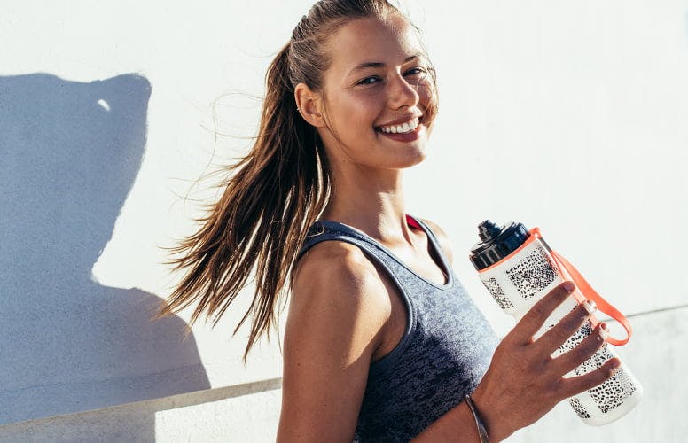 Woman smiling with water bottle