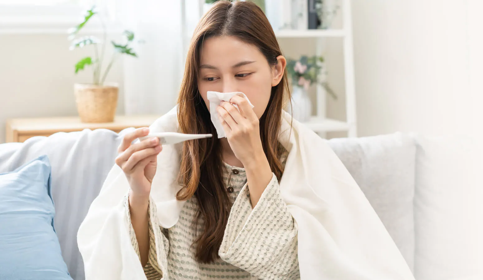 Banner for Category Finder tool of a sick woman on a couch, holding a tissue to her nose.