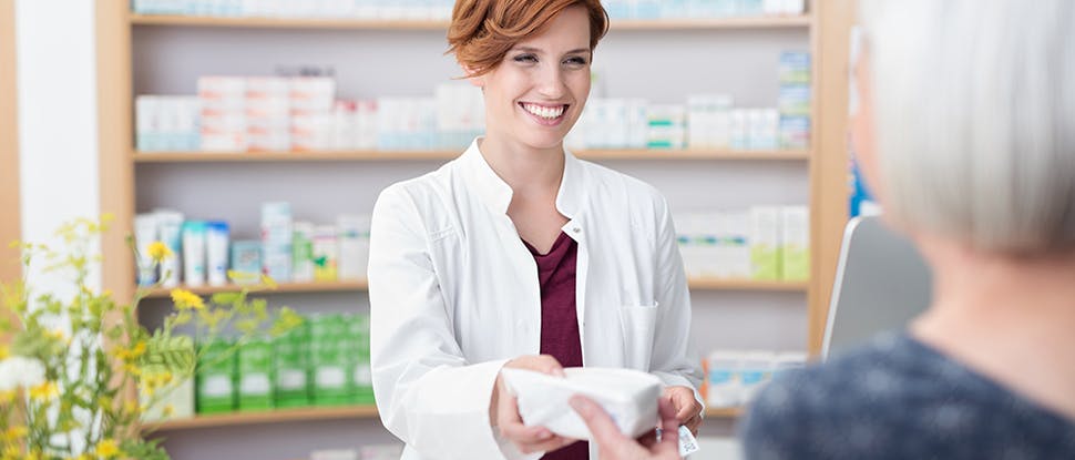 Pharmacist helping woman