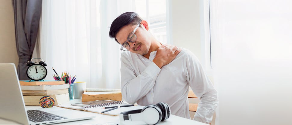 Ένας άντρας που κρατά τον ώμο του με πόνο