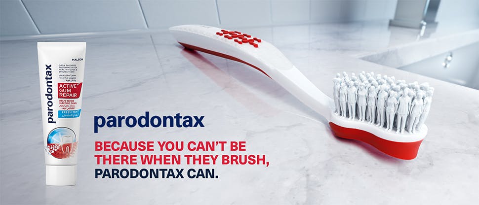 Close-up image of a toothbrush and a tube of parodontax Active Gum Repair toothpaste, along with the text “parodontax – because you can’t be there when they brush, parodontax can.”
