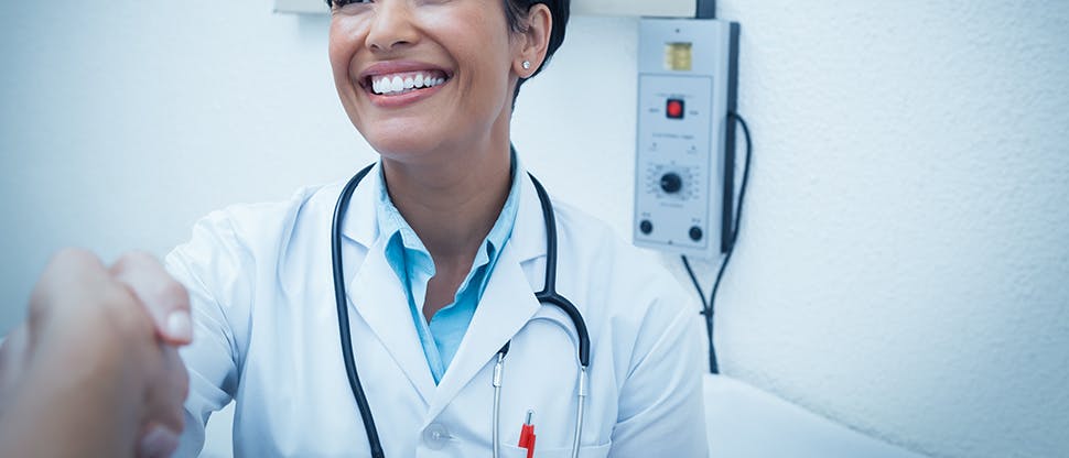 Smiling doctor shaking hands