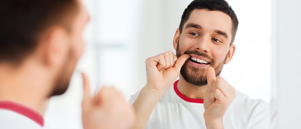 Man using dental floss