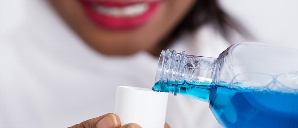 Woman pouring mouthwash