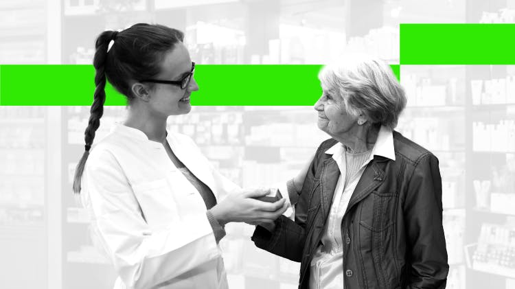 A young female pharmacist smiles while talking to an older female patient