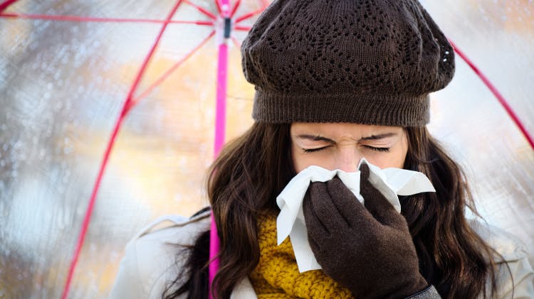 Lady under umbrella with flu