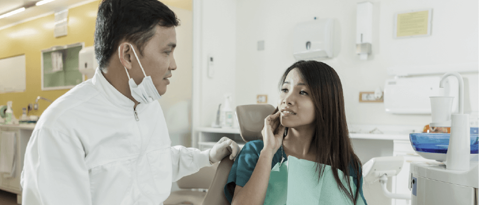 Image of dentist speaking with patient