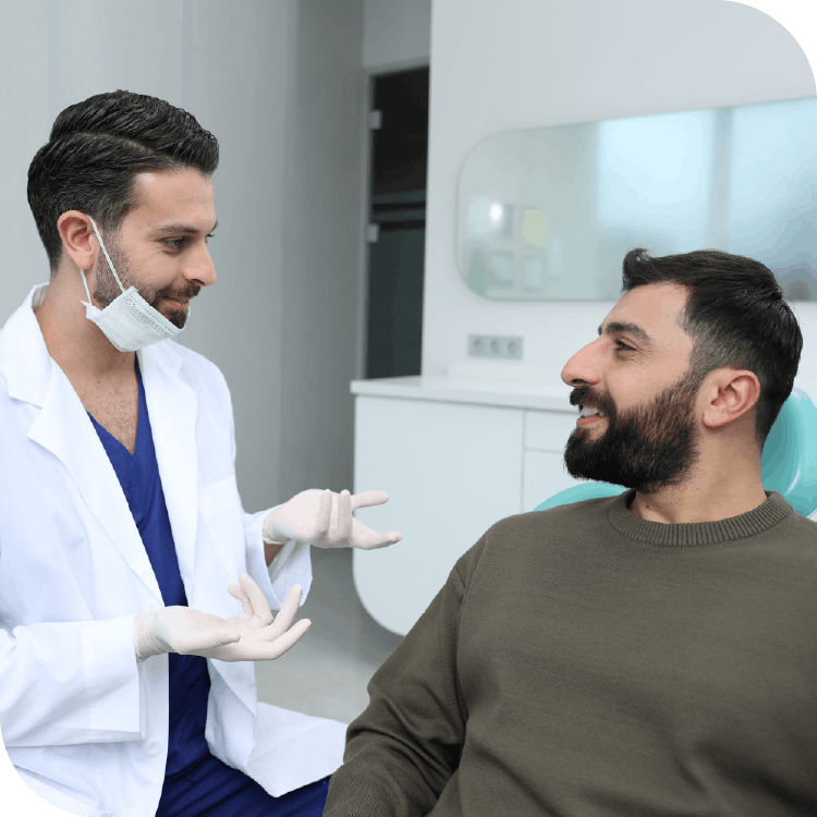 Arabic dentist talking to male patient