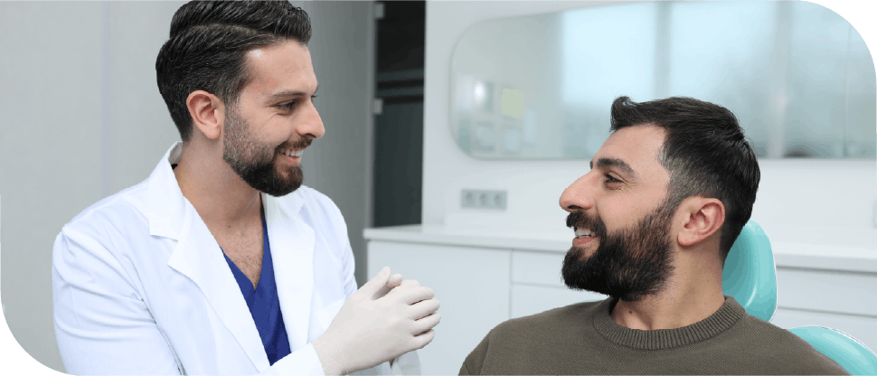 Male arab dentist caring for male patient